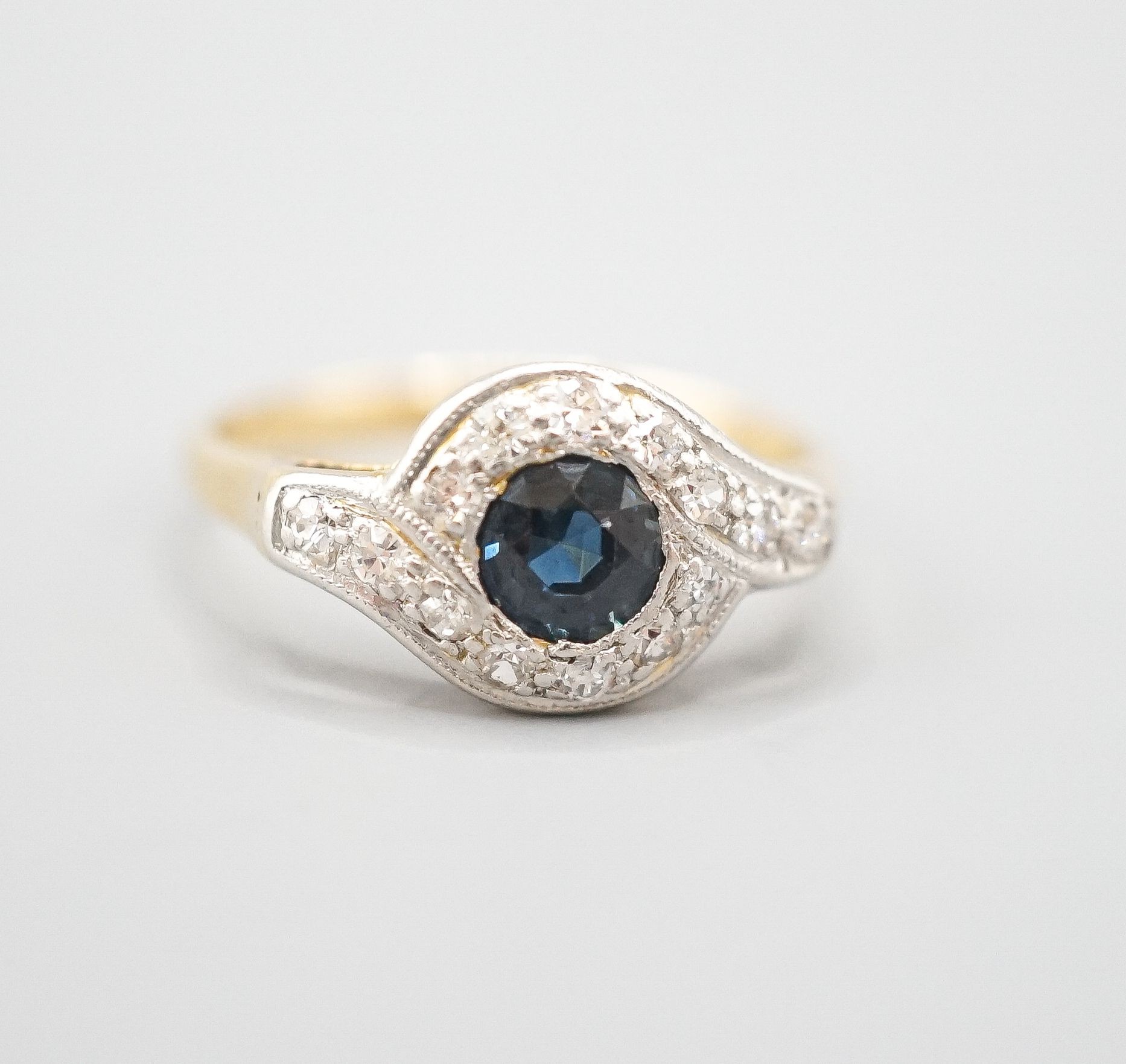 An early to mid 20th century 18ct, sapphire and diamond set cluster ring, size N/O, gross weight 2.6 grams.